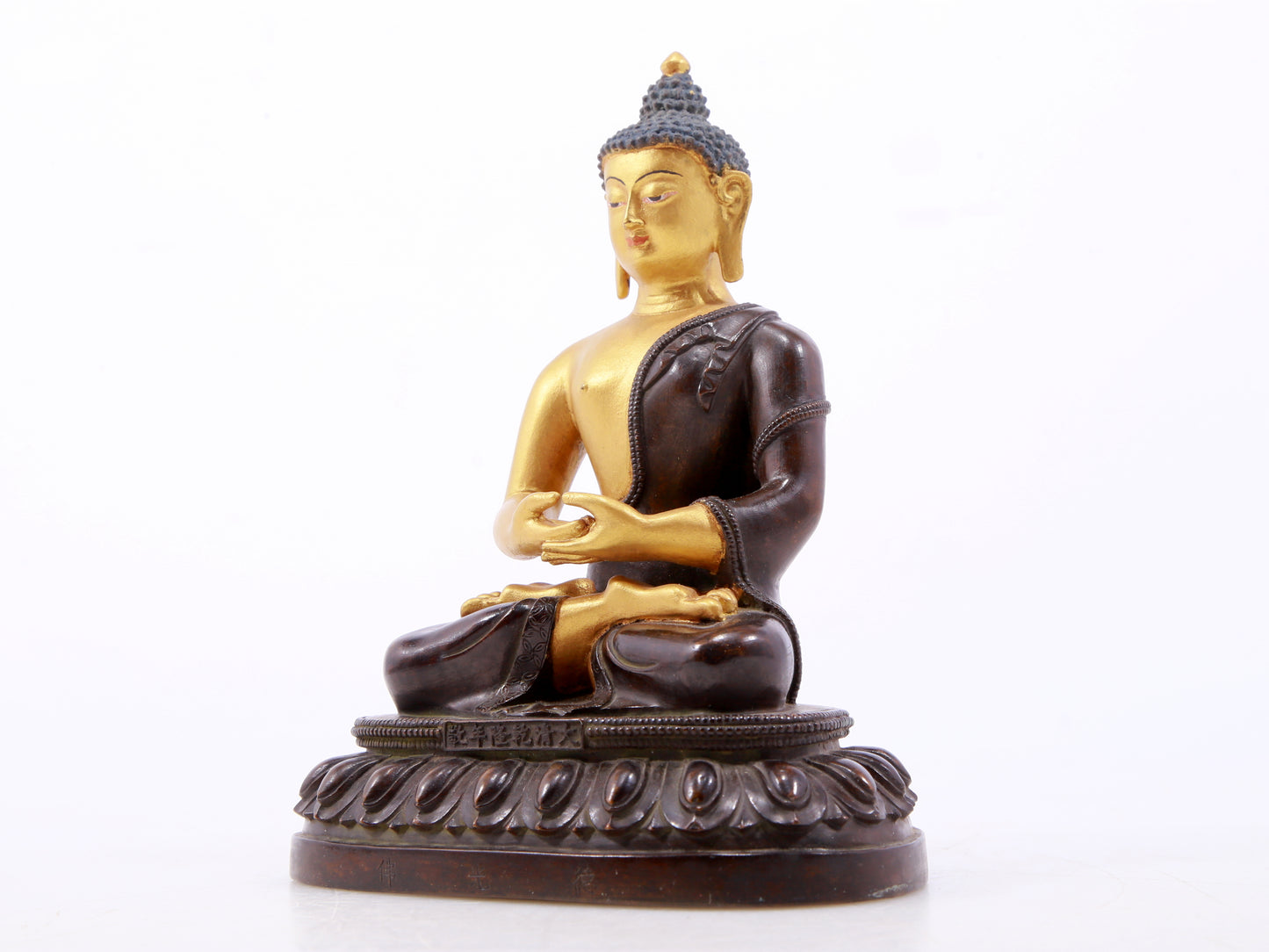 A serene gilt bronze statue of Gautama Buddha