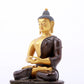 A serene gilt bronze statue of Gautama Buddha