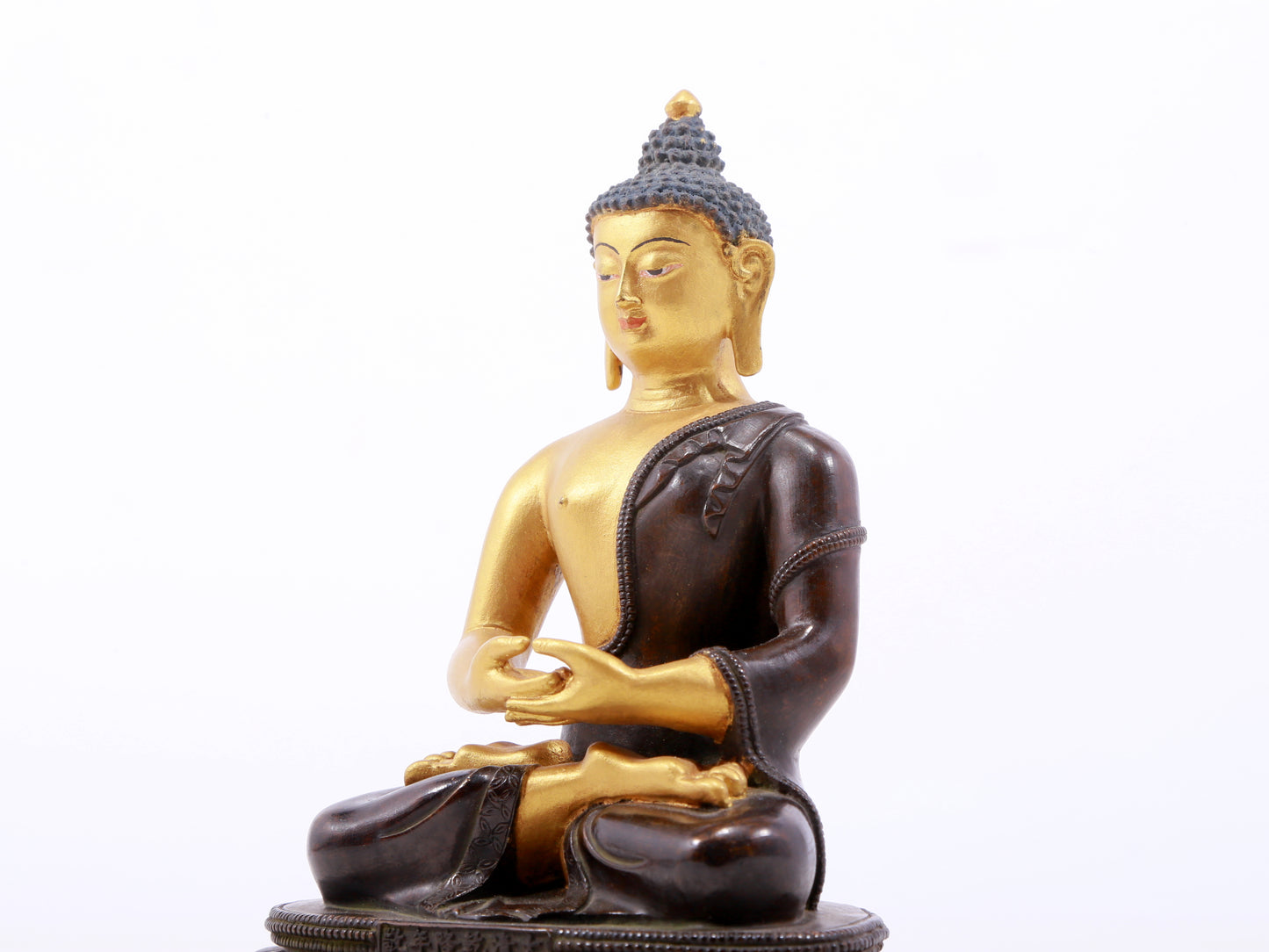 A serene gilt bronze statue of Gautama Buddha