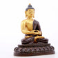 A serene gilt bronze statue of Gautama Buddha