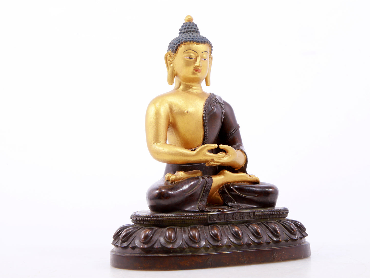 A serene gilt bronze statue of Gautama Buddha