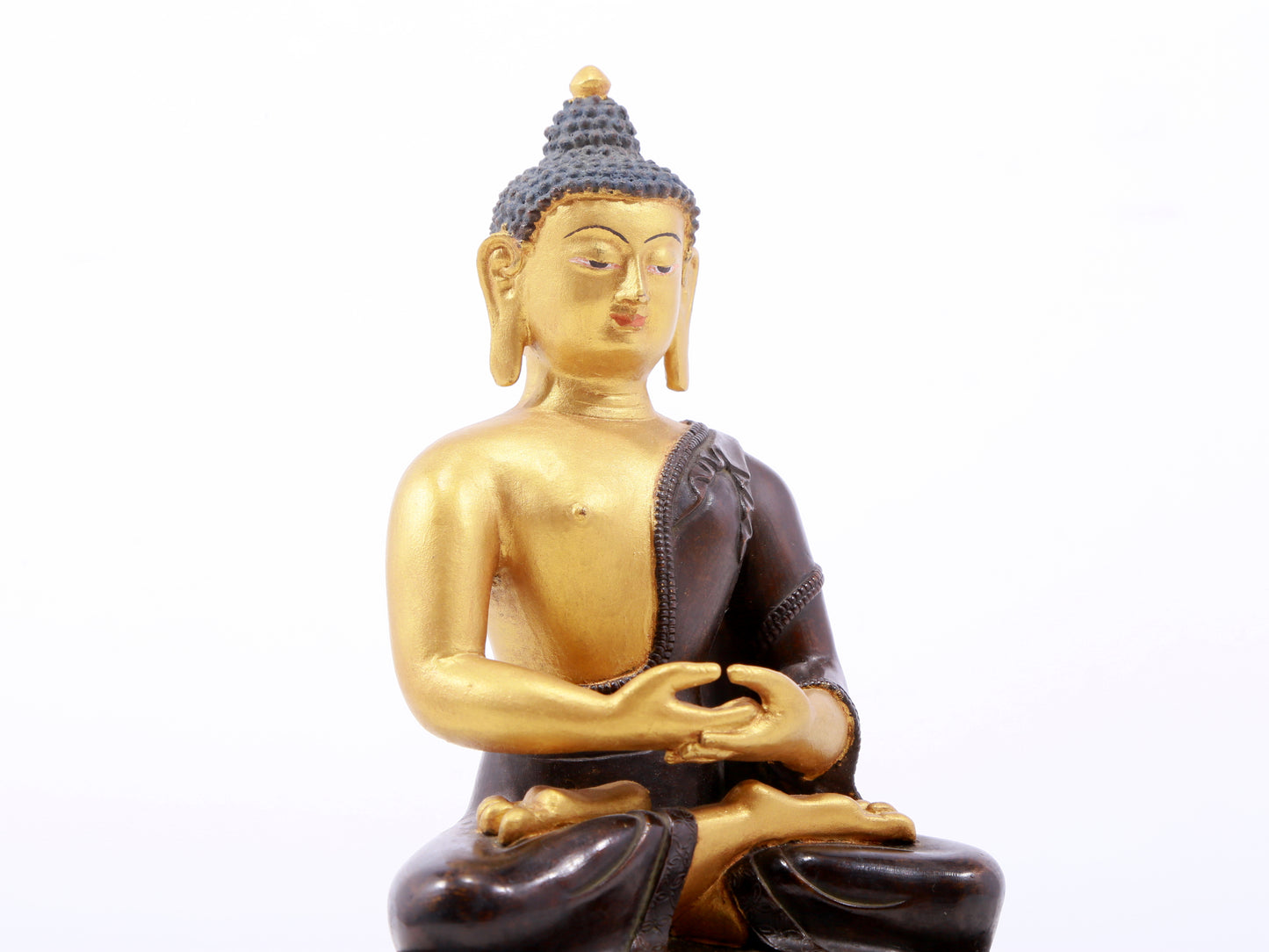 A serene gilt bronze statue of Gautama Buddha