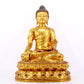 A serene gilt bronze statue of Gautama Buddha