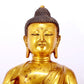 A serene gilt bronze statue of Gautama Buddha