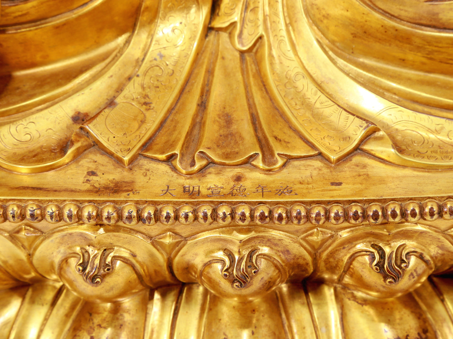 A serene gilt bronze statue of Gautama Buddha