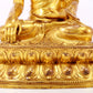 A serene gilt bronze statue of Gautama Buddha