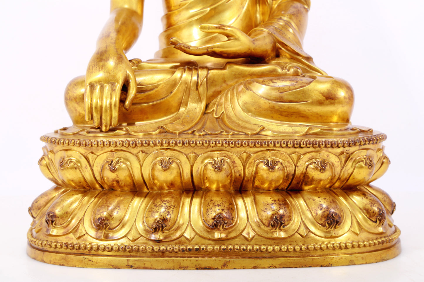 A serene gilt bronze statue of Gautama Buddha