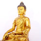 A serene gilt bronze statue of Gautama Buddha