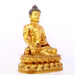 A serene gilt bronze statue of Gautama Buddha