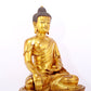 A serene gilt bronze statue of Gautama Buddha