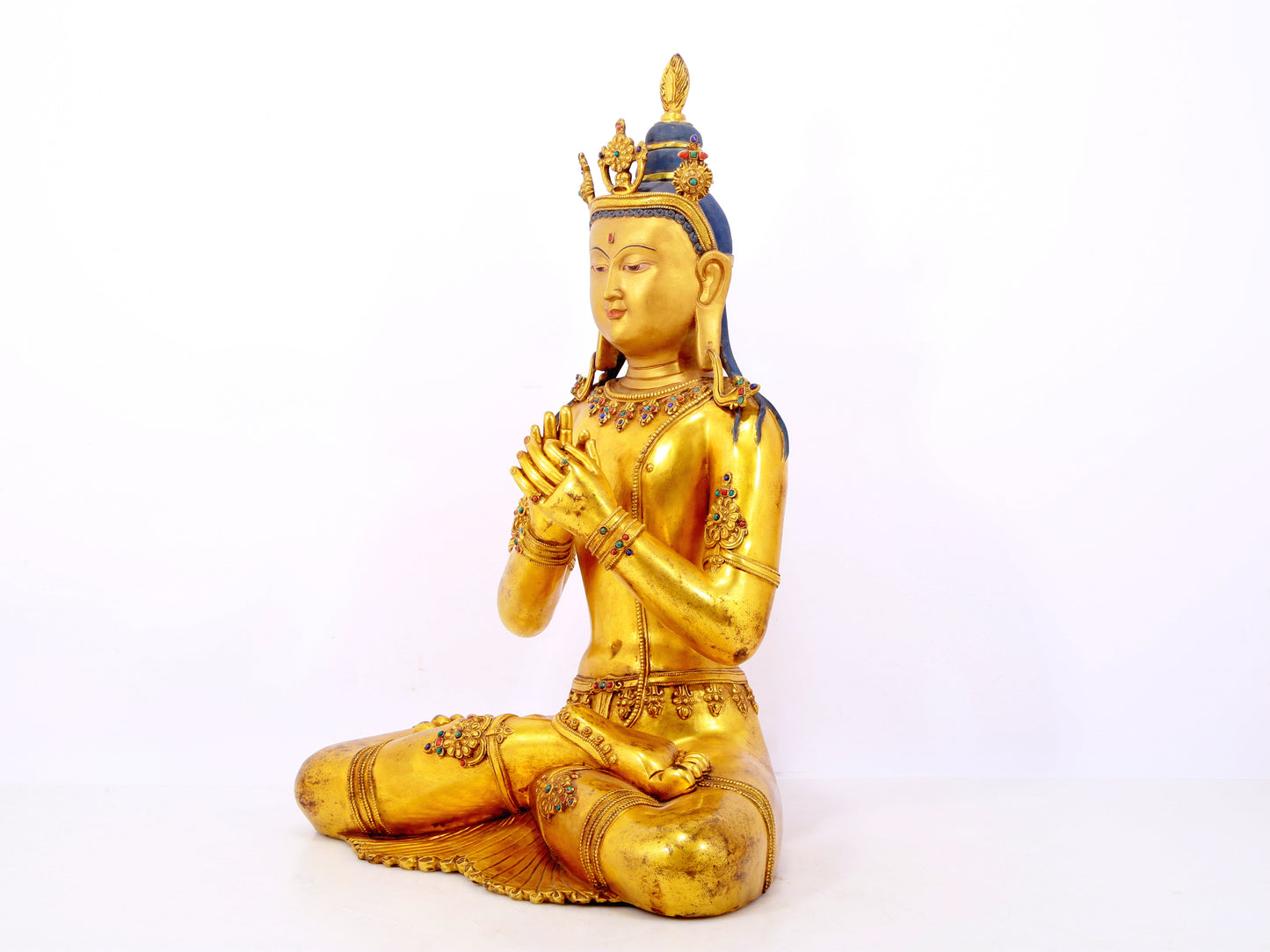 A serene gilt bronze statue of Bodhisattva inlaid with hundreds of treasures