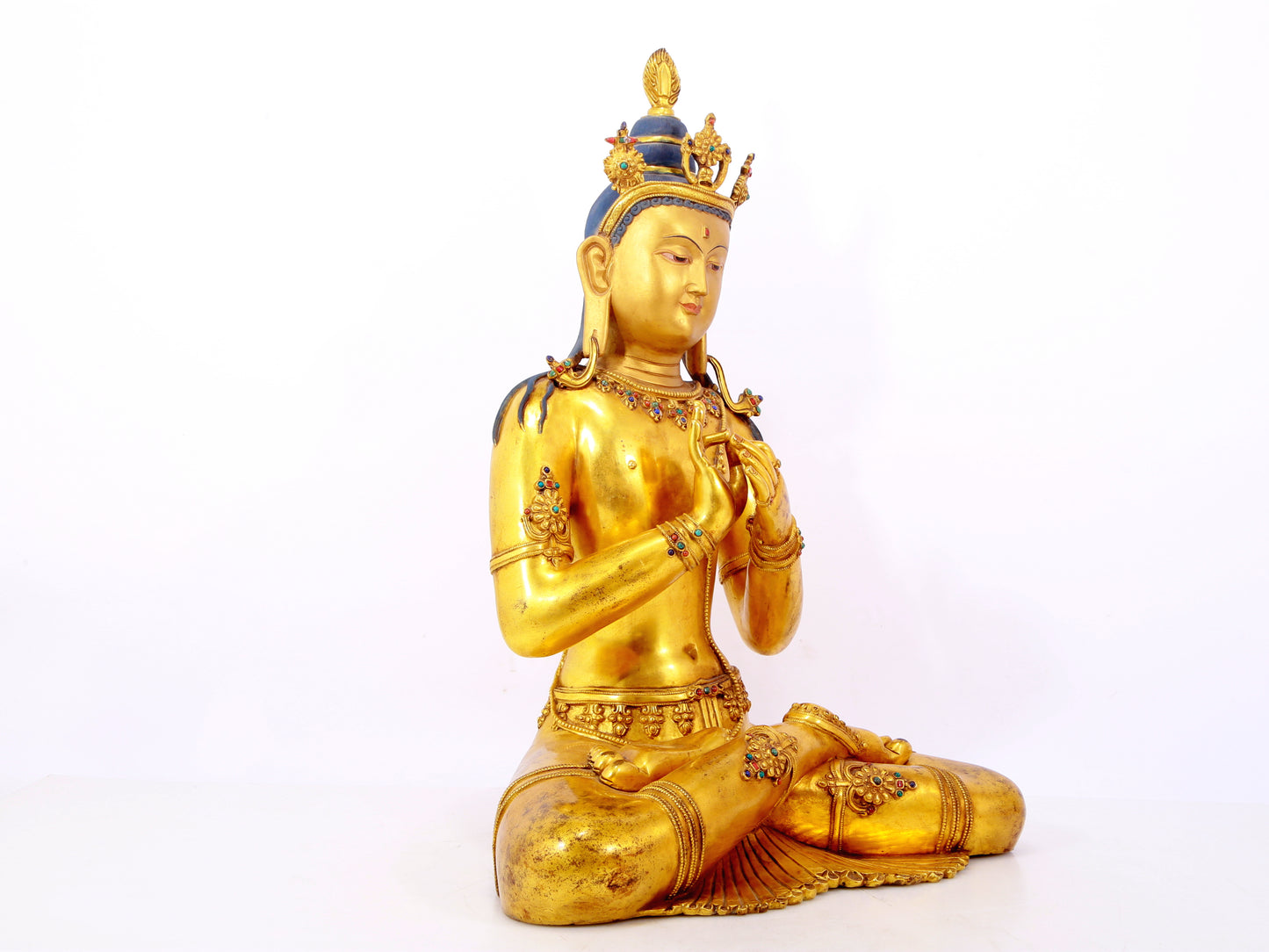 A serene gilt bronze statue of Bodhisattva inlaid with hundreds of treasures