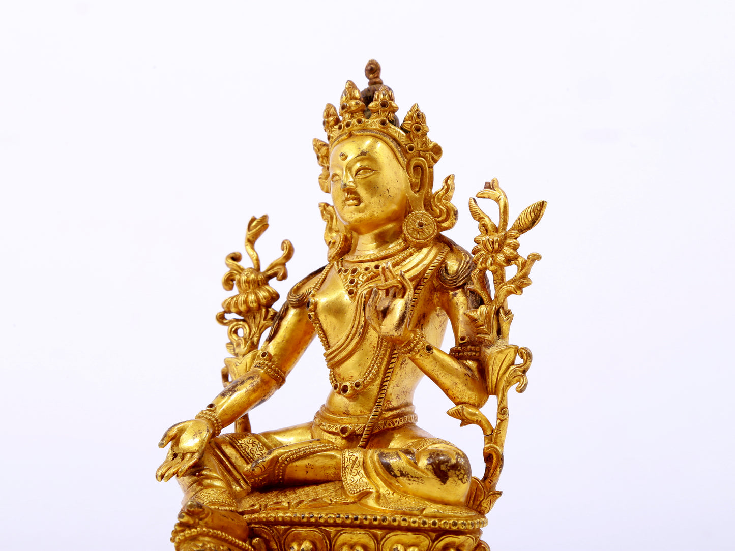 A serene gilt bronze green Tara statue