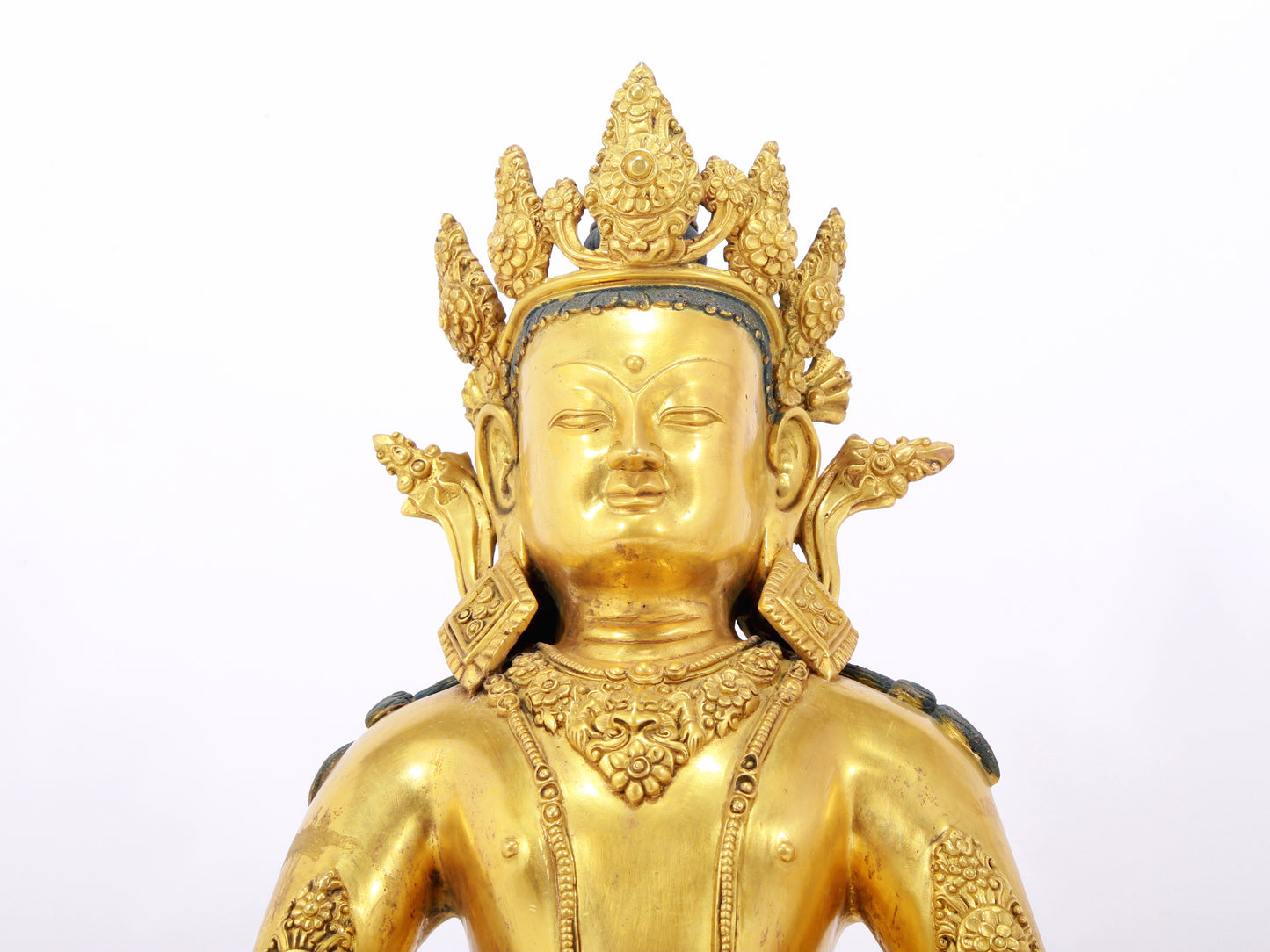 A serene gilt bronze statue of Amitayus Buddha