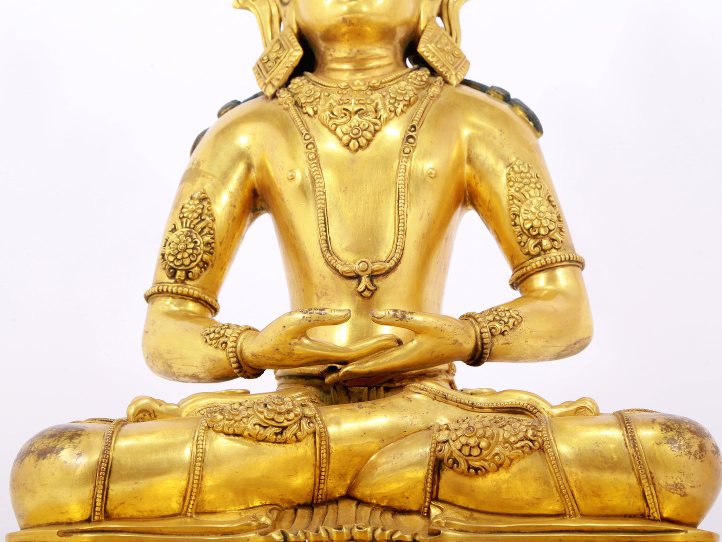 A serene gilt bronze statue of Amitayus Buddha