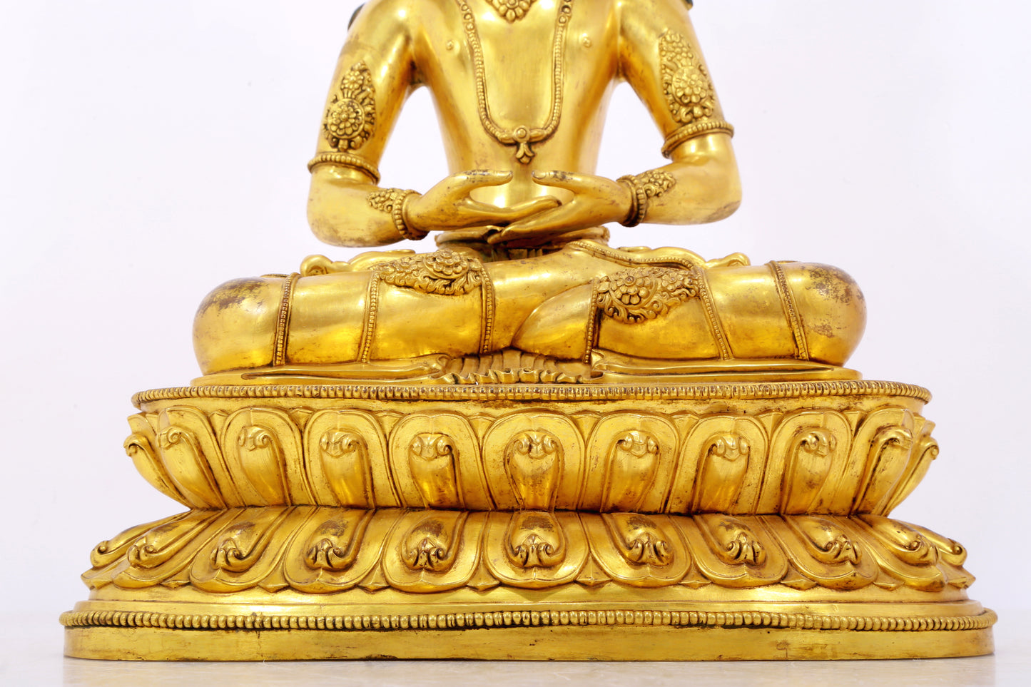 A serene gilt bronze statue of Amitayus Buddha