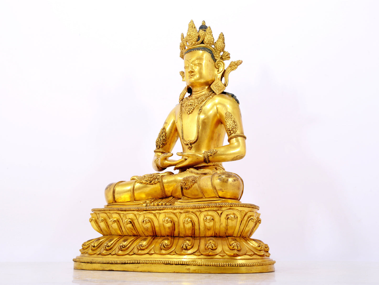 A serene gilt bronze statue of Amitayus Buddha