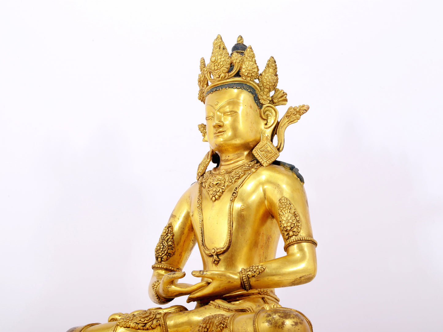 A serene gilt bronze statue of Amitayus Buddha