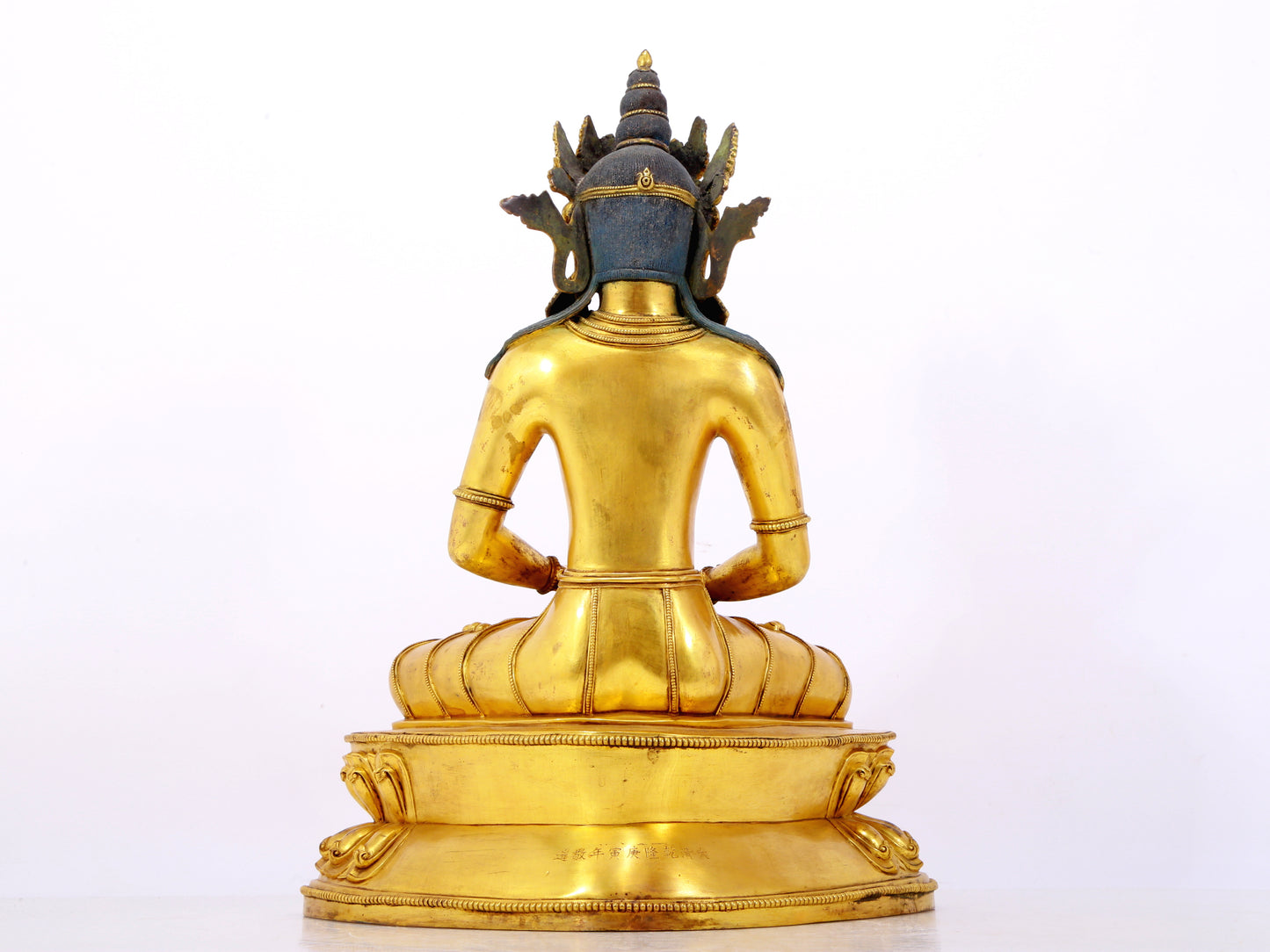 A serene gilt bronze statue of Amitayus Buddha