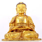 A serene gilt bronze statue of Gautama Buddha