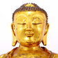 A serene gilt bronze statue of Gautama Buddha