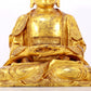 A serene gilt bronze statue of Gautama Buddha