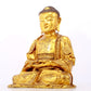 A serene gilt bronze statue of Gautama Buddha