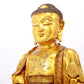 A serene gilt bronze statue of Gautama Buddha