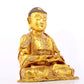 A serene gilt bronze statue of Gautama Buddha