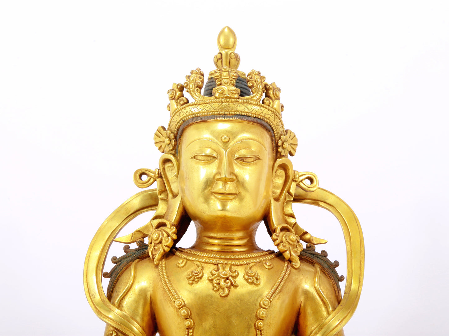 A serene gilt bronze statue of Amitayus Buddha