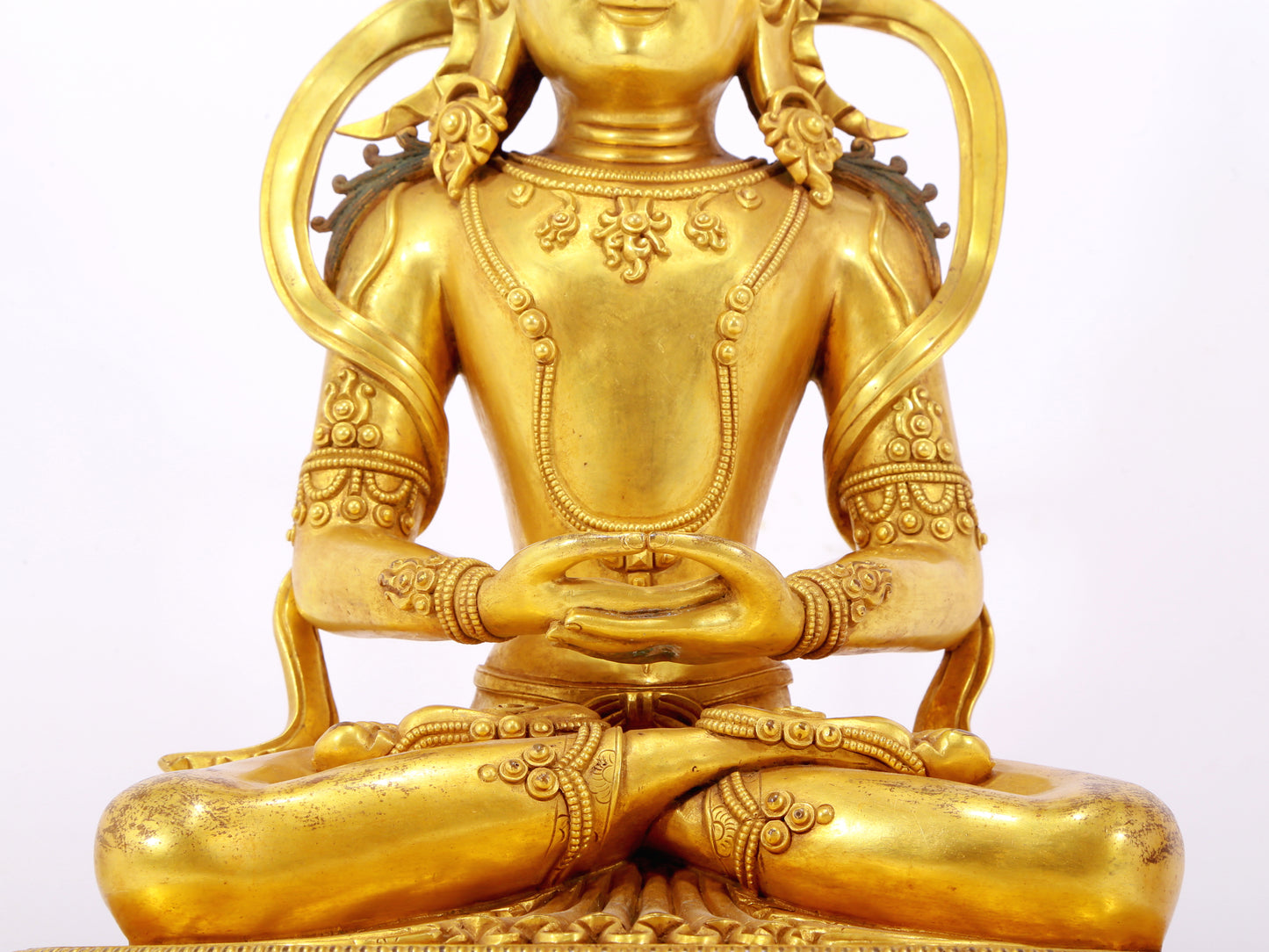 A serene gilt bronze statue of Amitayus Buddha