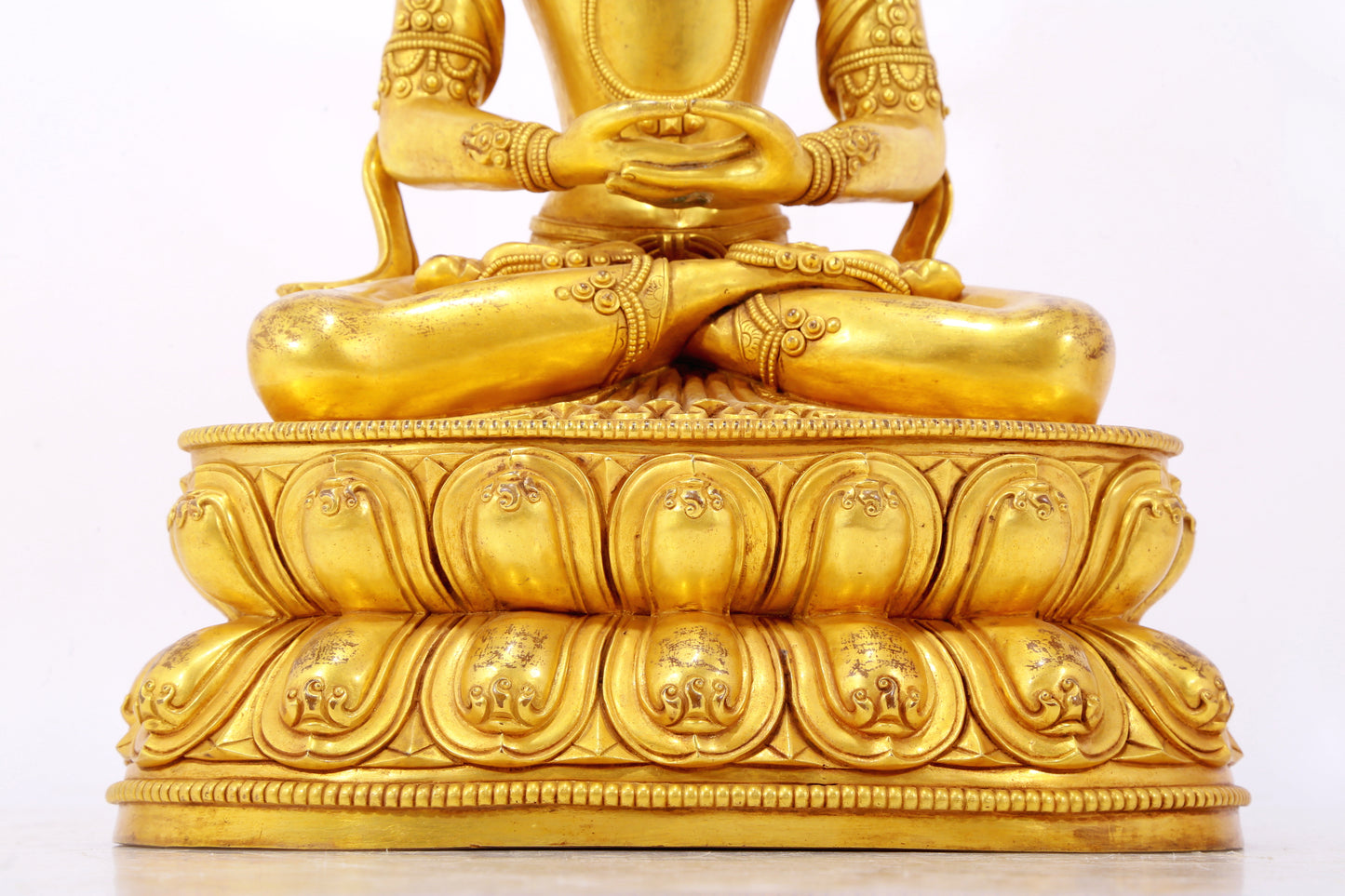 A serene gilt bronze statue of Amitayus Buddha