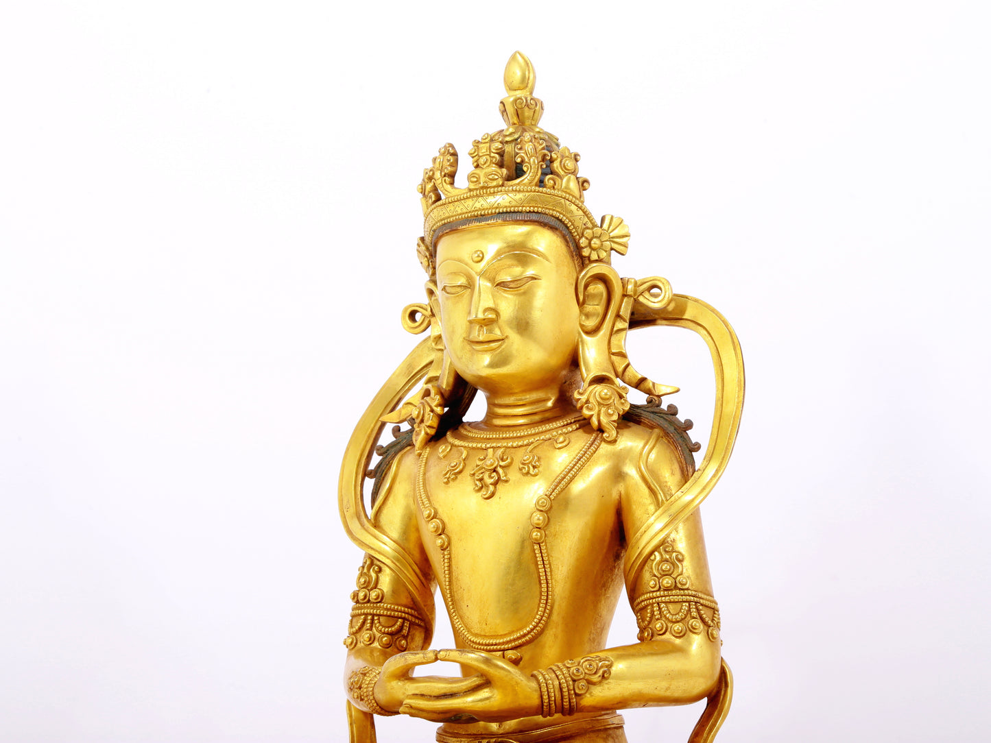 A serene gilt bronze statue of Amitayus Buddha