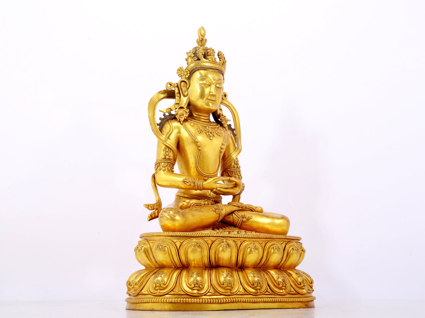 A serene gilt bronze statue of Amitayus Buddha