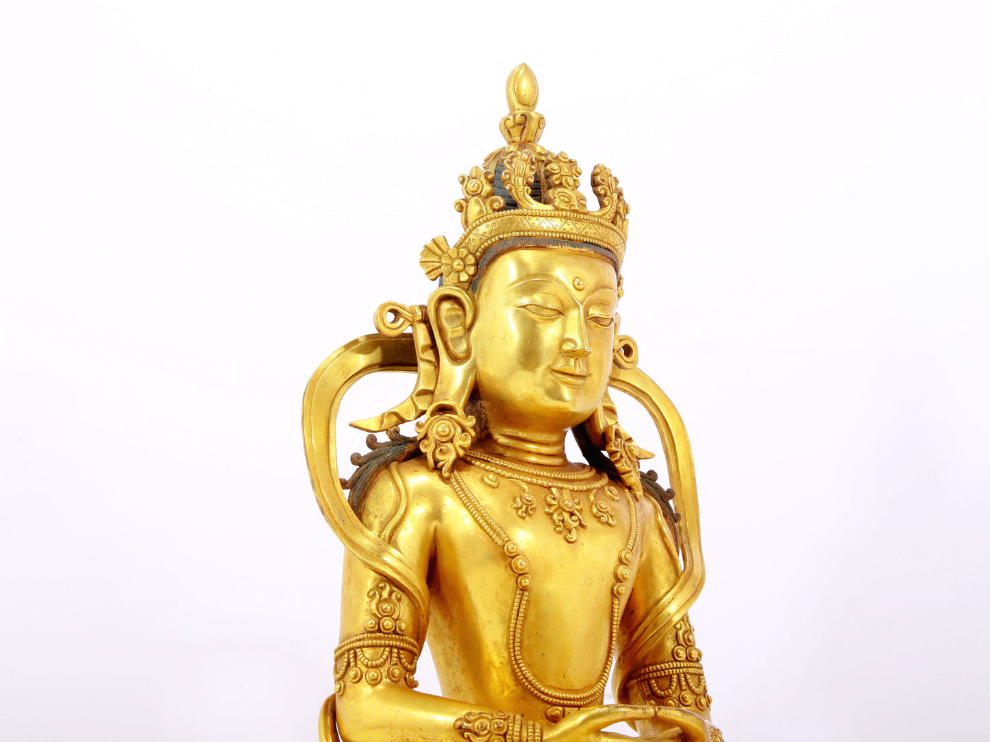 A serene gilt bronze statue of Amitayus Buddha