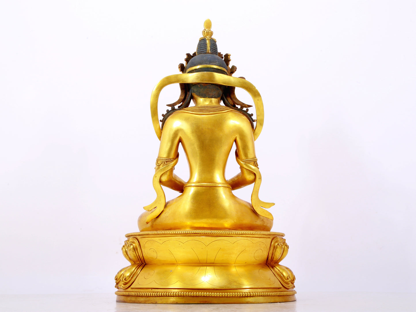 A serene gilt bronze statue of Amitayus Buddha