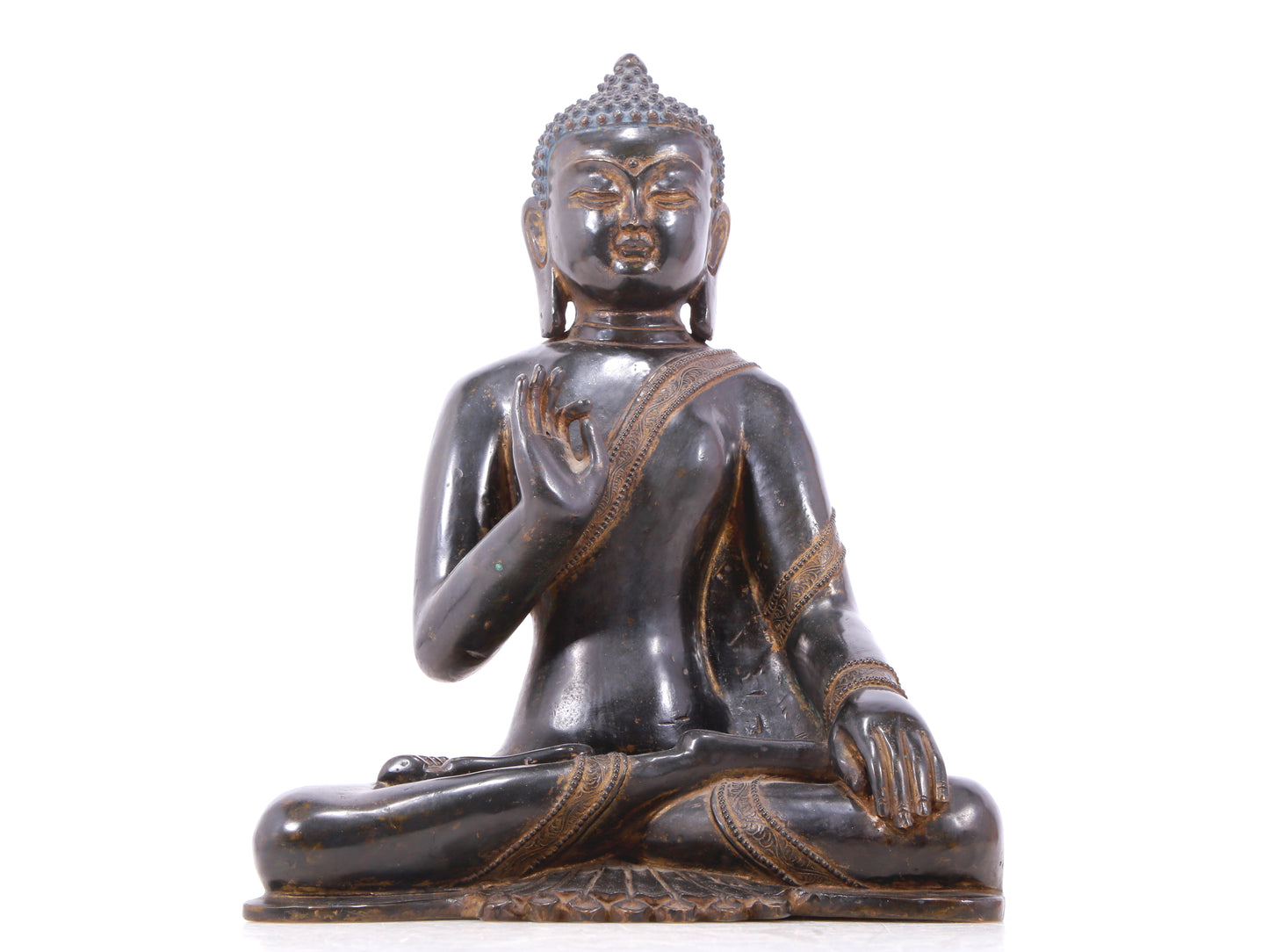 A serene gilt bronze statue of Gautama Buddha