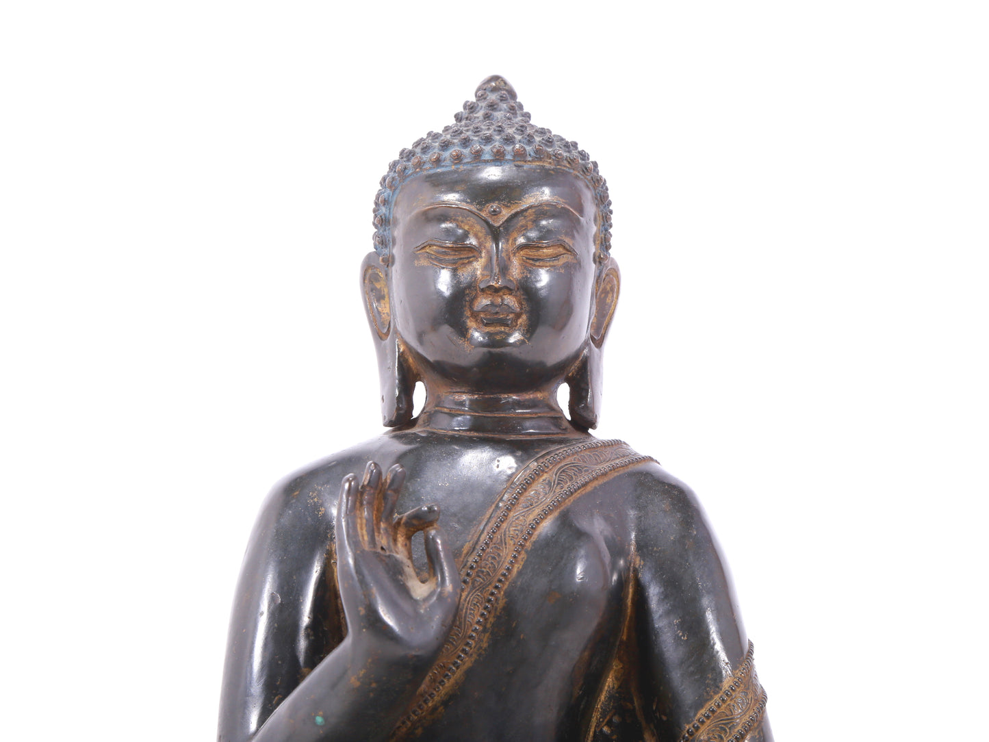 A serene gilt bronze statue of Gautama Buddha