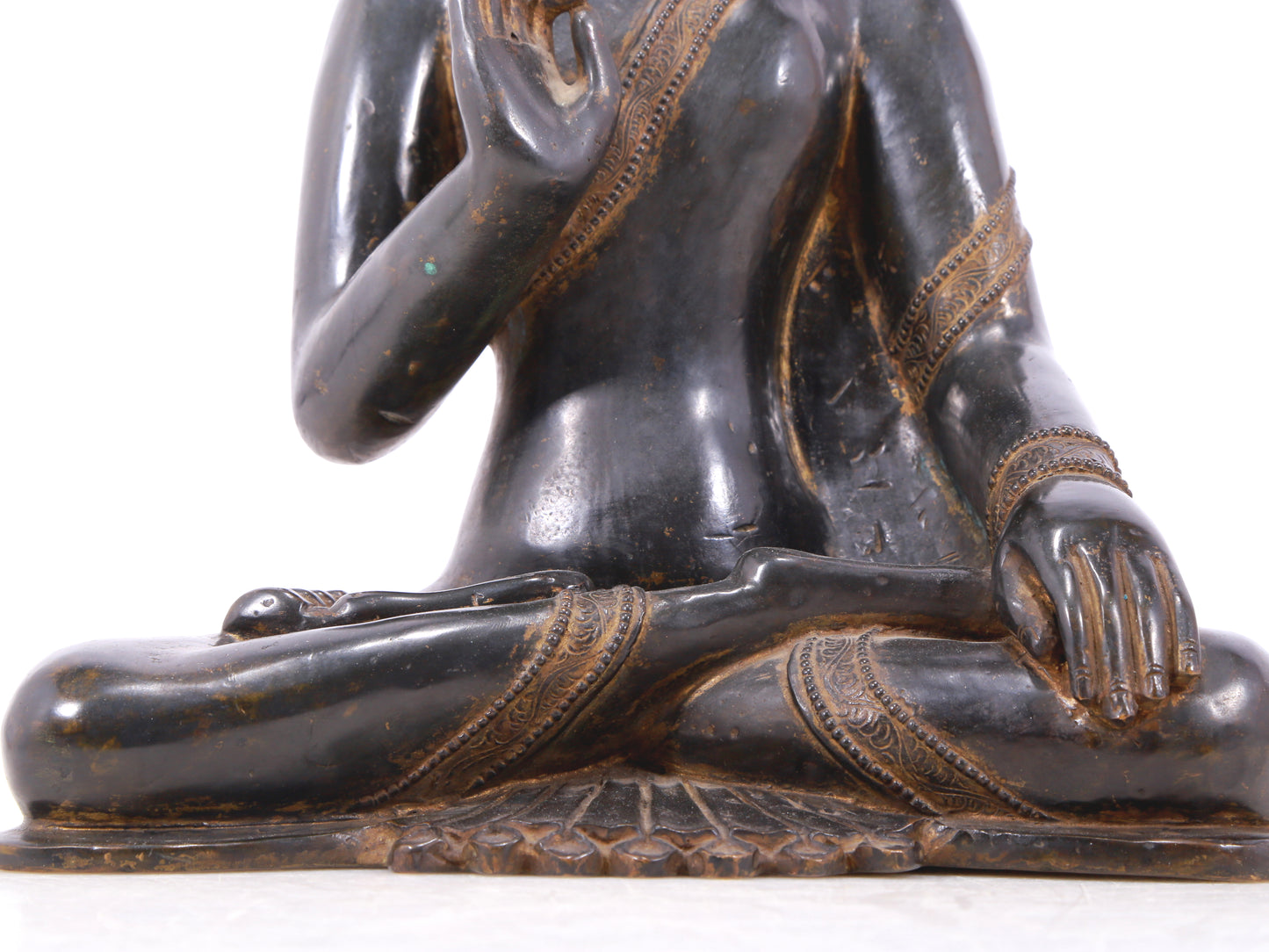 A serene gilt bronze statue of Gautama Buddha