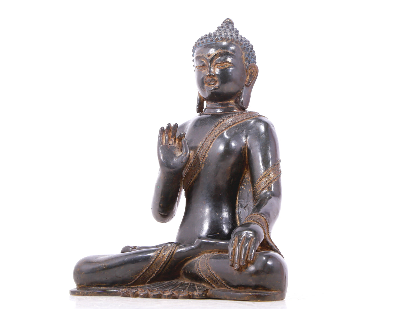 A serene gilt bronze statue of Gautama Buddha