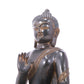 A serene gilt bronze statue of Gautama Buddha