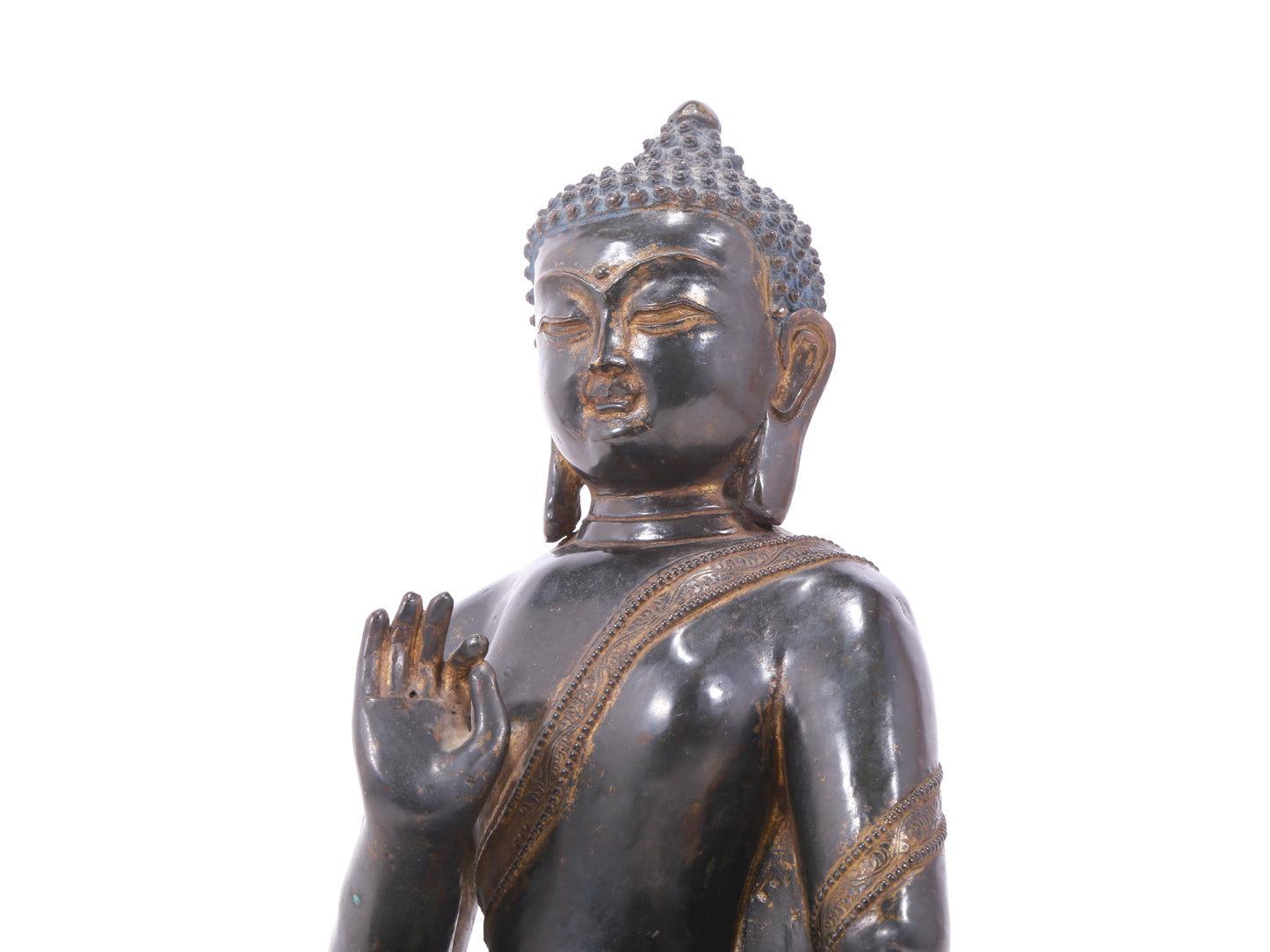 A serene gilt bronze statue of Gautama Buddha