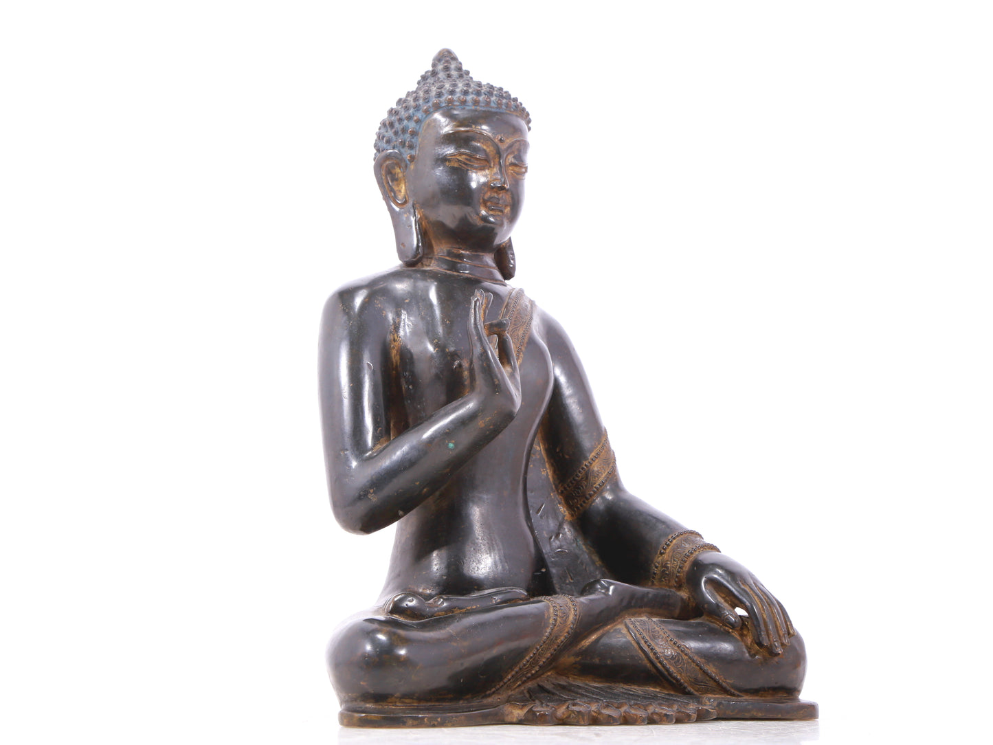 A serene gilt bronze statue of Gautama Buddha