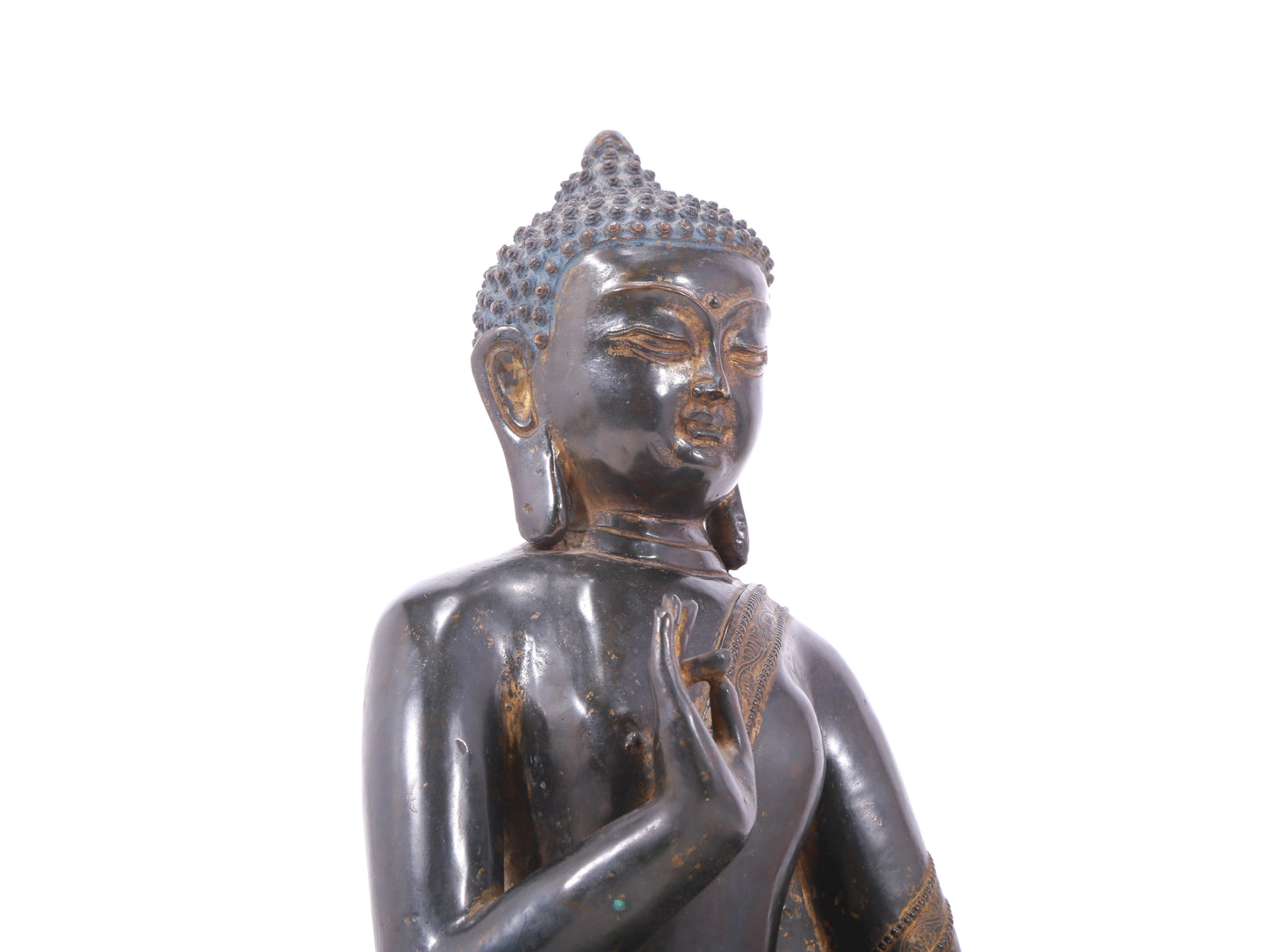 A serene gilt bronze statue of Gautama Buddha