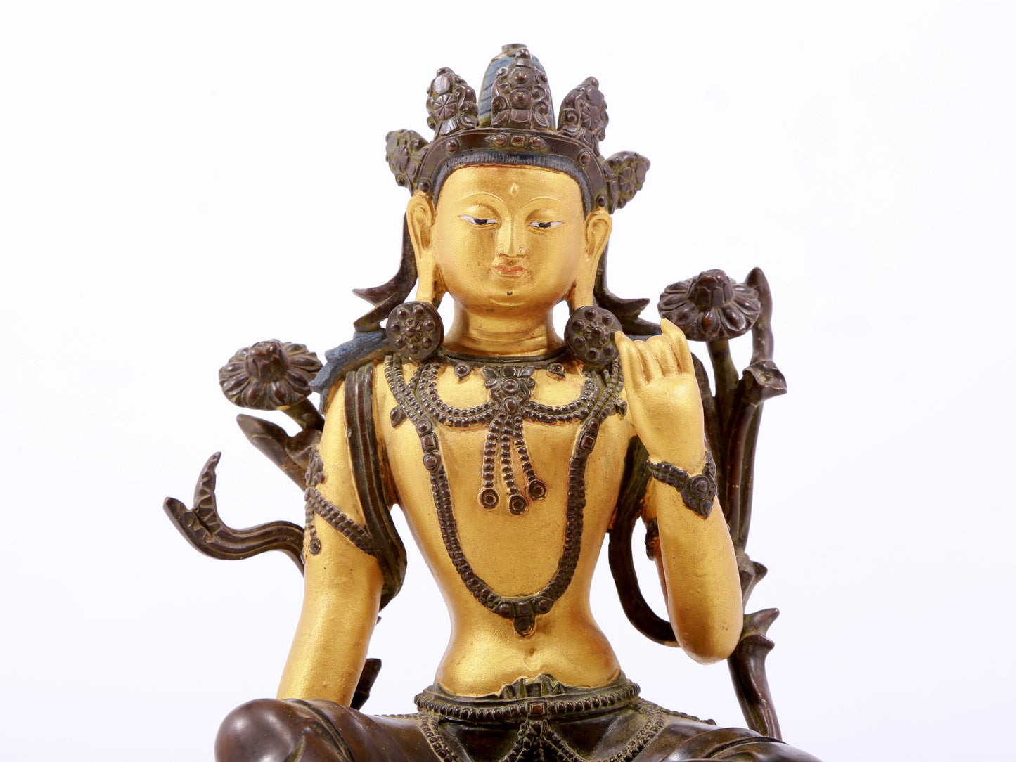 A serene gilt bronze green Tara statue