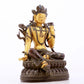 A serene gilt bronze green Tara statue