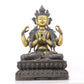 A serene gilt bronze four-armed Guanyin statue