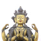 A serene gilt bronze four-armed Guanyin statue