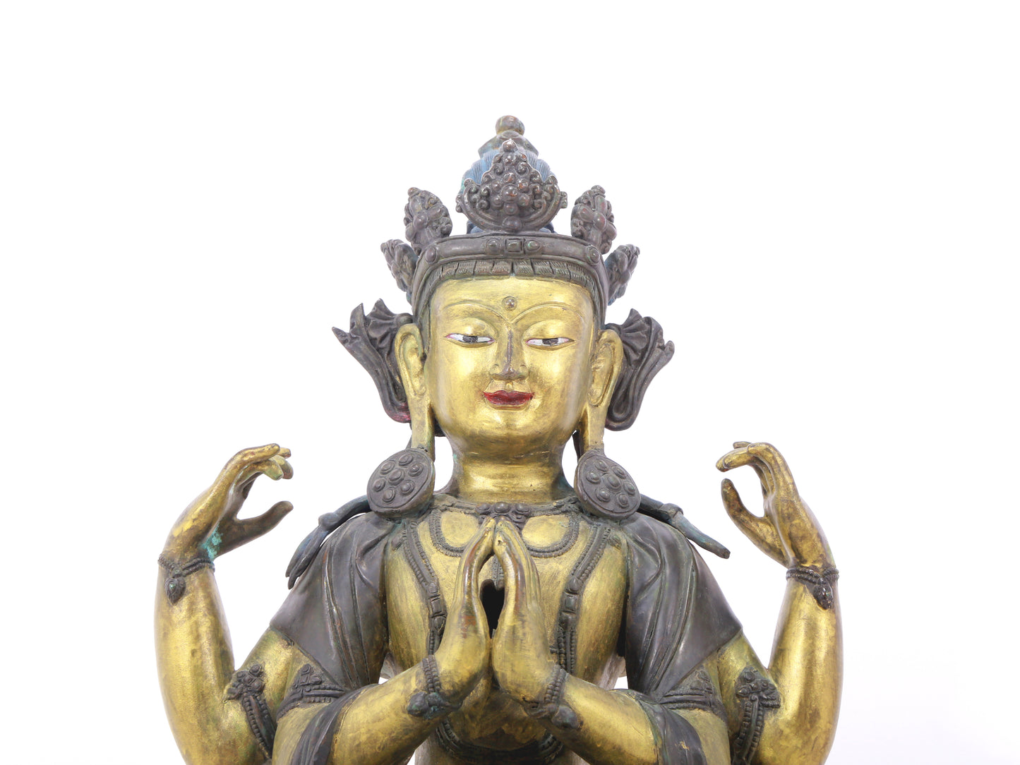 A serene gilt bronze four-armed Guanyin statue