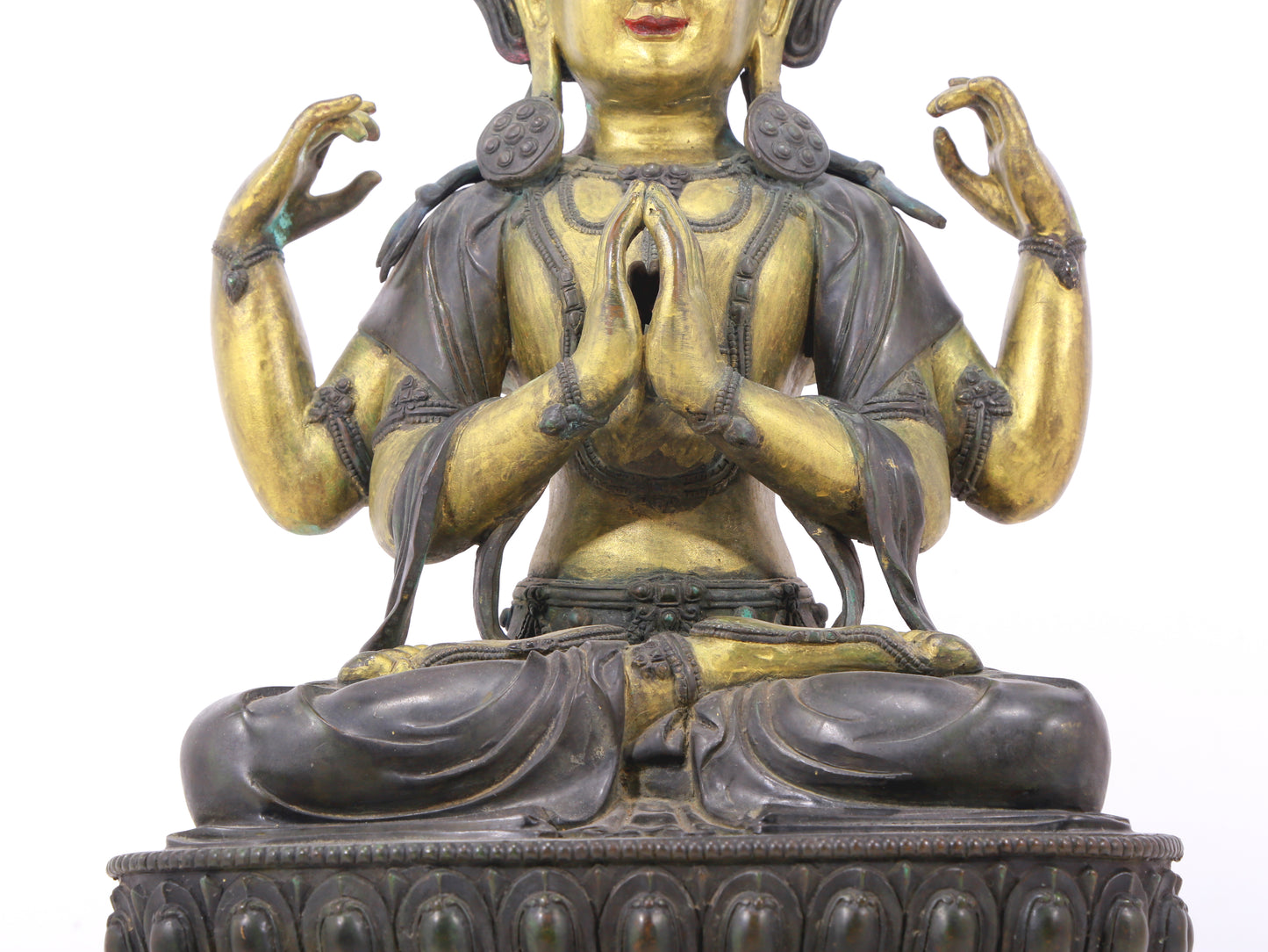 A serene gilt bronze four-armed Guanyin statue